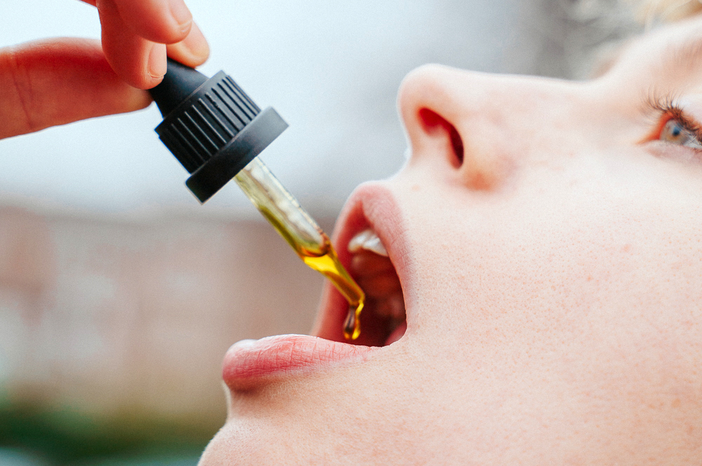 A woman taking her dose of CBD oil