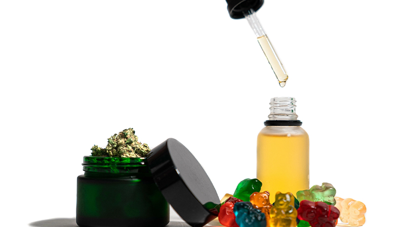 CBD oil, CBD gummies, and hemp buds in white background